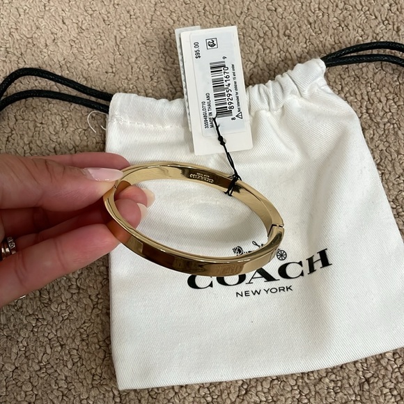 COACH. Brand new. Pegged Signature Hinged Bangle. Gold. Tags attached. - Picture 2 of 3